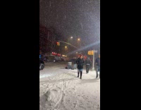 Submitter walks on the street while snowing