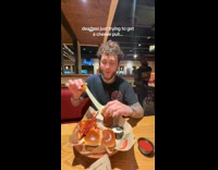 Man doing cheese pull interrupted by fight inside restaurant