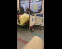 Guy eats giant popcorn on bus 