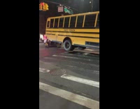 Two truck tows yellow school bus 