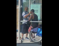 Guy gets haircut on sidewalk 