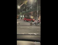 Person pushing bike across crosswalk and multiple strollers