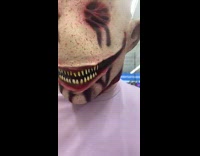 Guy scares little girl with mask