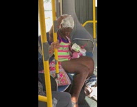 Woman neon pink green shirt dyes her hair on metro train