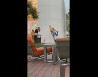 Two girls balance yoga position outside Apple store