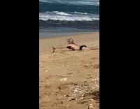 Woman take pictures of Barbie doll near a turtle