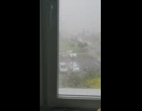 Storm strong wind and rain outside window
