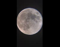 Super moon through telescope night time 