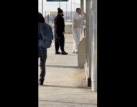 Two men rap video at train station