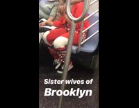 man has arms around two women sitting on train