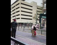 Girl sits chair holds pink foil balloons 
