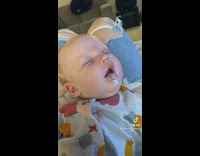 Baby daughter on moms lap passed out with a messy mouth full of milk