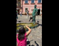 Collab IITW - Lady Helps Man Pose with Fountain Statue