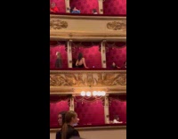 Woman black dress poses on opera balcony Part 2
