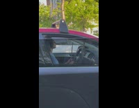Guy practicing drums on steering wheel in traffic