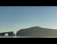 Four birds fly in the clear sky at the ocean