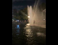 Random guy showers at public park fountain