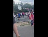 White balloon floating through crowd kicked