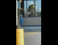 Woman in blue workout outfit poses outside the gym