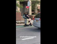 A couple and their dog on a backpack all sharing one electric scooter 