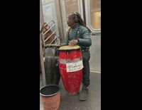 Man plays congas inside the train cart