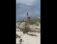 Guy yellow shirt lay on grass beach