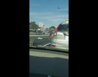 Guy gets out of car during traffic on freeway and kicks down orange cones