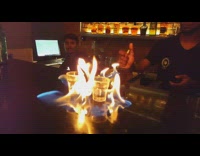 Bartender lights two shots on fire 