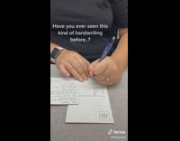 Woman writing on paper sideways 