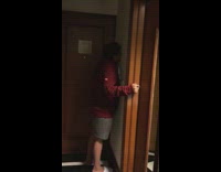 Red sweater grey shorts guy kisses wall 