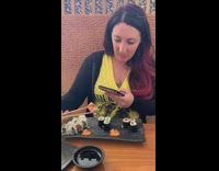 Woman takes picture of sushi roll