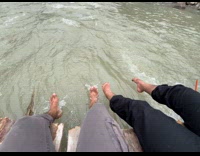 Submitter with friend dips feet on river 