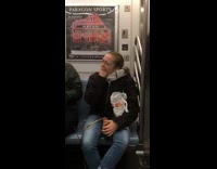 woman puts whole fist in mouth crowded subway