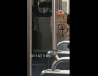 Homeless man on subway train holds up cardboard sign that says Too Ugly to Prostitute 