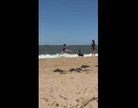 Woman in bikini ballet jump at the beach