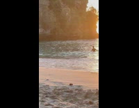 People with their own photoshoot at the beach at sunset