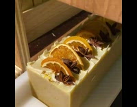 Girl cuts soap with dried orange slice 