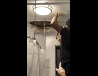 Collab WINY - Man remove parts of apartment bathroom ceiling