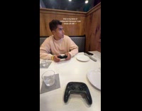 Couple dining at nerdvana playing mario kart