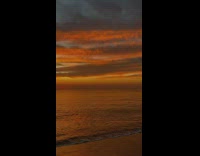 Beach sunset orange sky cloudy