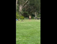 Shirtless guy resistance bands deadlift workout park