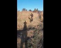 Guy falls off green bicycle bump dirt 