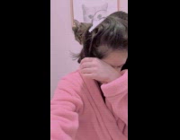 Cat walk around shoulder of woman pink robe