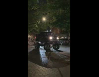 Van on Monster Wheels Waits for Stoplight