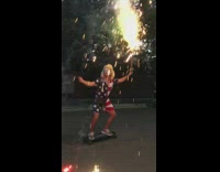 Guy skateboards while holding firework
