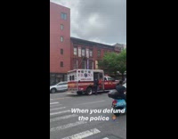 Multiple firetrucks spiderman costume guy pedestrian light 