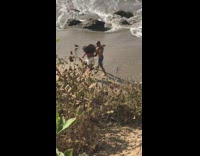 Couple dance mess up laugh beach sand