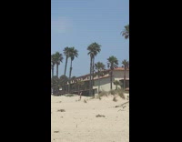 Man shirtless chased another man at the beach