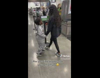 Kid Holds and Leads Young Lady in Supermarket