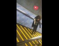 Girl glasses dancing up sideways yellow stairs train station